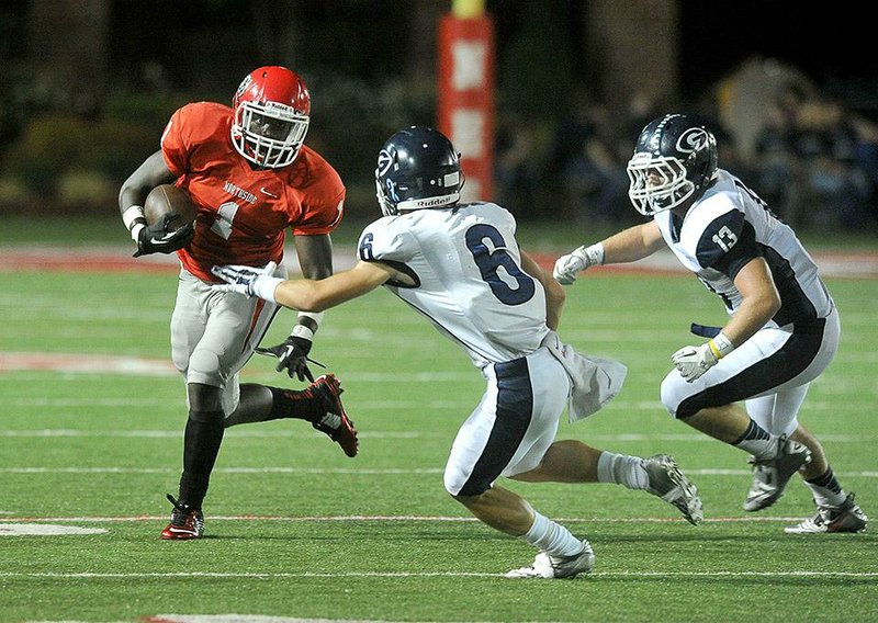 NWA Media/Michael Woods --09/18/2014-- w @NWAMICHAELW...  Fort Smith Northside runnungback Justin Curry tries to shake Greenwood defenders Hughes Kolton (6) and  Cole Jackson (13) as he runs the ball during the first half of Friday nights game in Fort Smith