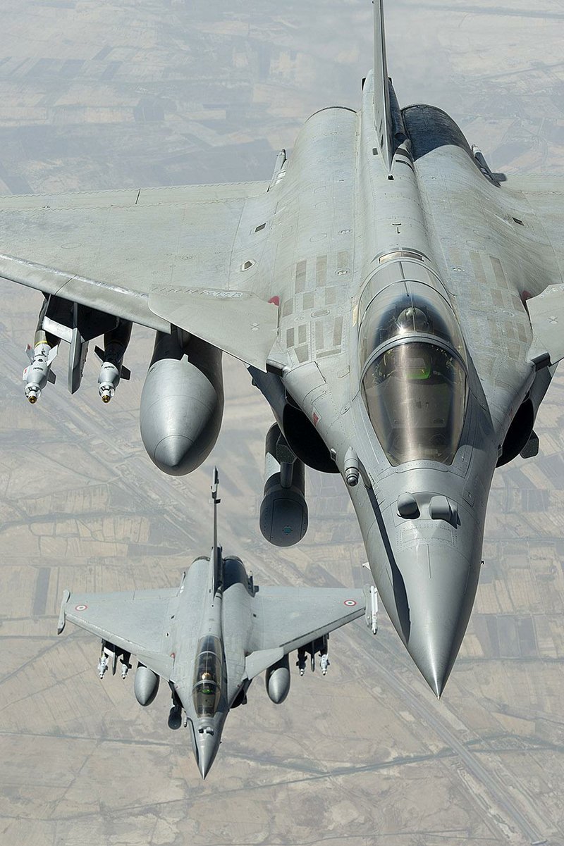 Two Rafale jet fighters soar Friday over Iraq in an image provided by the French army. French warplanes struck at the Islamic State group Friday, destroying a logistics depot, Iraqi and French officials said.