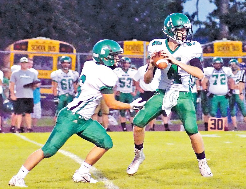  Staff Photo Randy Moll Cole Self, Greenland quarterback, prepares to hand off to Alex Sizemore on Friday during their game against Gentry at Pioneer Stadium in Gentry.