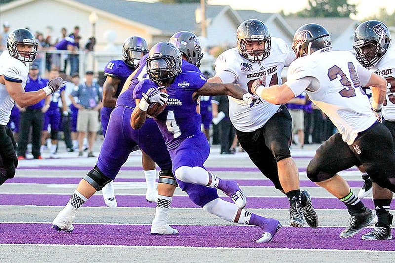 Central Arkansas receiver Jatavious Wilson looks for running room as Missouri State safety Caleb Schaffitzel (34) tries to make the tackle in the first half of Missouri State’s 33-31 victory Saturday night at Estes Stadium in Conway.