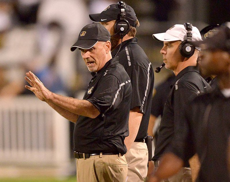 Former Bentonville High coach Barry Lunney coaches his team during a game Sept. 19, 2014.