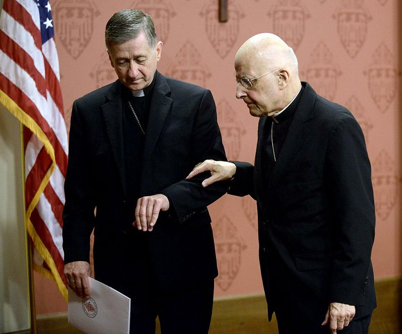 Cardinal Francis George, right, retiring leader of the Archdiocese of Chicago right, walks away from the podium with help from newly-appointed Archbishop of Chicago, Archbishop Blase Cupich left, after George spoke to the media during a press conference in Chicago, Saturday, Sept. 20, 2014. (AP Photo/Paul Beaty)