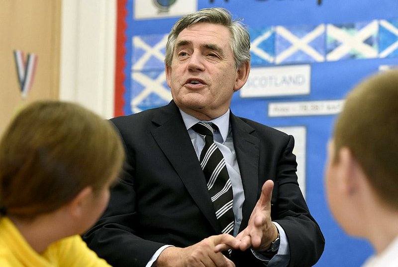 Former British Prime Minister Gordon Brown and NO campaigner in Scotland's Independence Referendum meets pupils at Kelty Primary school Kelty Scotland Friday Sept. 19, 2014.  Voters in Scotland resoundingly rejected independence in a historic referendum that shook the country to its core.  But No does not mean a return to the status quo. The referendum led to promises of further powers for each of the four nations in the United Kingdom _ a pledge that will change the country forever.  (AP Photo/Garry F McHarg/PA) UNITED KINGDOM OUT NO SALES NO ARCHIVE