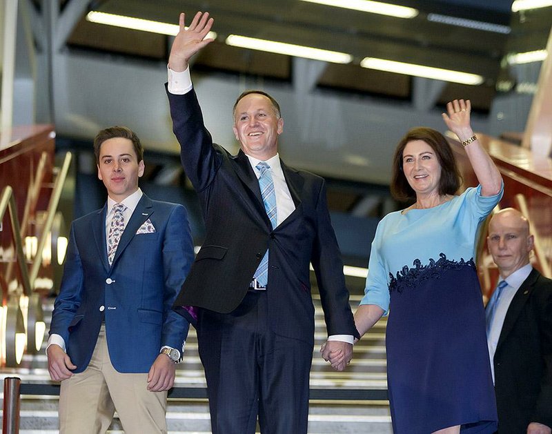 New Zealand's Prime Minister John Key, center,  waves as he and his wife, Bronagh, right, and son Max, left, arrive at an election party for supporters after winning the national election in Auckland, New Zealand, Saturday, Sept. 20, 2014. Key won an emphatic victory in New Zealand's general election to return for a third term in office, a result that will be seen as an endorsement of the way Key's National Party has handled the economy. (AP Photo/New Zealand Herald, Mark Mitchell) NEW ZEALAND OUT, AUSTRALIA OUT