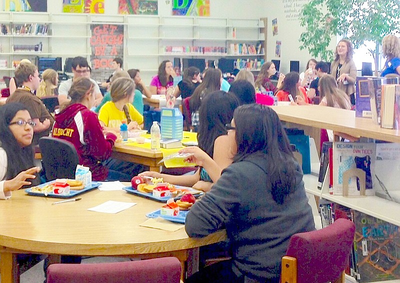 Submitted photo Teens read: Students and faculty at Lake Hamilton High School discuss "The Maze Runner" during the first meeting of the Teen Reads Book Club in the school's library.