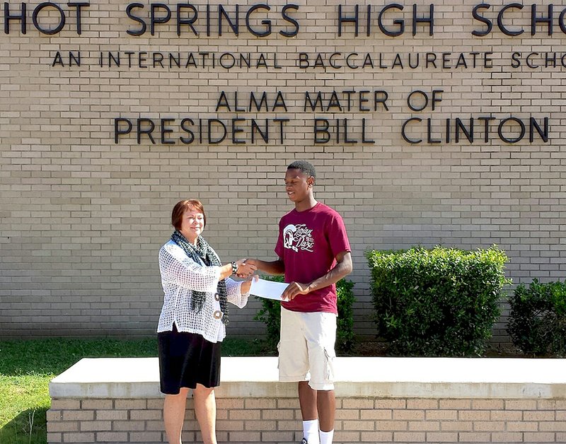 Submitted photo Trojan future: Tyren Tidwell, right, is presented a scholarship by Brenda Hagerich, representing the HSHS Class of 1968. Tidwell is the first scholarship recipient named by the Class of 1968, which hopes to provide more scholarships in the future.