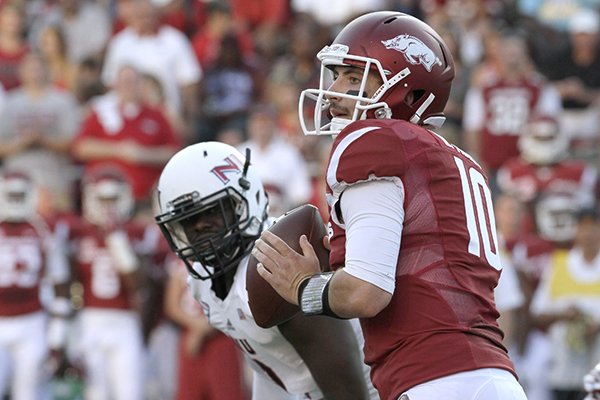 Arkansas quarterback Brandon Allen (10) passes as he is rushed by Northern Illinois cornerback Shawun Lurry in the first quarter of an NCAA college football game in Fayetteville, Ark., Saturday, Sept. 20, 2014. (AP Photo/Danny Johnston)
