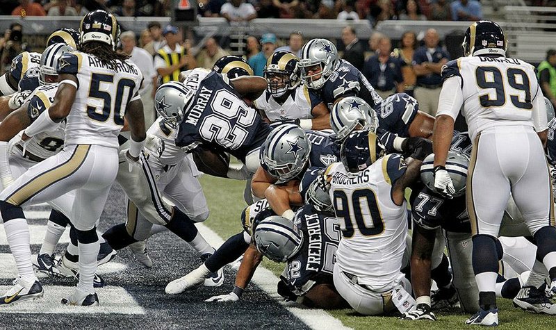 Dallas Cowboys running back DeMarco Murray (29) scores against the St. Louis Rams during the second quarter on Sunday, Sept. 21, 2014, at Edward Jones Dome in St. Louis. (Paul Moseley/Fort Worth Star-Telegram/MCT)