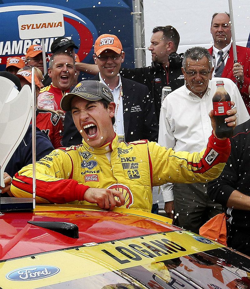 Joey Logano celebrates in Victory Lane after winning the NASCAR Sprint Cup series auto race at New Hampshire Motor Speedway in Loudon, N.H., Sunday, Sept. 21, 2014. (AP Photo/Cheryl Senter)