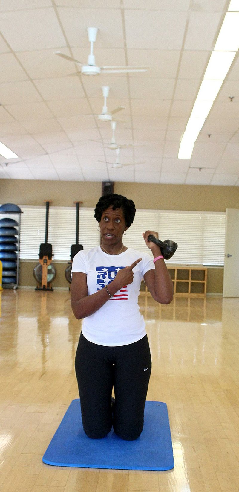 Arkansas Democrat-gazette/CELIA STOREY
Brenda Ngozi Stallings gets ready to do the Kneeling Single Arm Stand exercise for Matt Parrott's Master Class column in ActiveStyle.