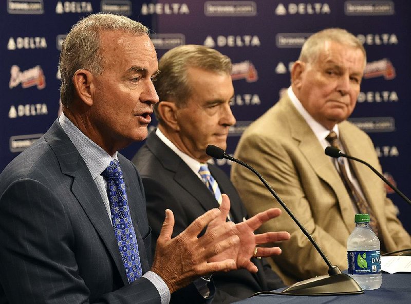 Atlanta Braves interim general manager John Hart, left, answers questions with team president John Schuerholz and former manager Bobby Cox, right, after the baseball team fired general manager Frank Wren following a mid-summer collapse that caused the franchise to miss the playoffs, Monday, Sept. 22, 2014, in Atlanta. (AP Photo/David Tulis)