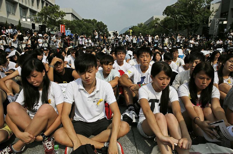 Students attend a rally at the Chinese University of Hong Kong campus in Hong Kong, Monday, Sept. 22, 2014. Thousands of Hong Kong students boycotted classes Monday to protest Beijing’s decision to restrict electoral reforms in a weeklong strike marking the latest phase in the battle for democracy in the southern Chinese city. (AP Photo/Vincent Yu)
