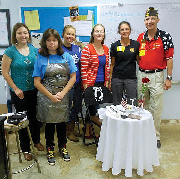 Submitted photo The Hot Springs Village Ladies Auxiliary of the Veterans of Foreign Wars Post 10483 presented the &#8220;Missing Man Table&#8221; ceremony to Rana Ward&#8217;s high school art class on Friday at Jessieville High School in observance of National POW/MIA Recognition Day 2014. Among the students in attendance were, from left, Leslie Friederich, Amy Enlow, and Raeanne Hall, with Ward, Monica Martin, Ladies Auxiliary Americanism chairwoman, and Rick Martin, post commander.
