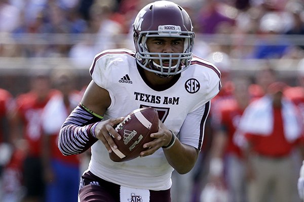 Texas A&M quarterback Kenny Hill (7) scrambles out of the pocket in the first half of an NCAA college football game against SMU, Saturday, Sept. 20, 2014, in Dallas. (AP Photo/Tony Gutierrez)