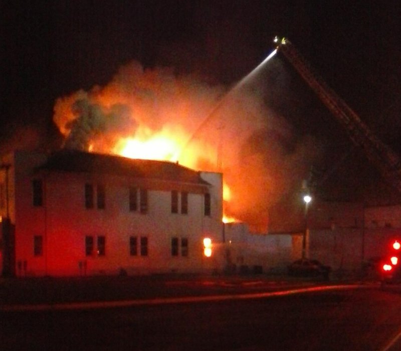 Flames shoot from the top of the Arkansas County annex courthouse the morning of Sept. 23, 2014. 