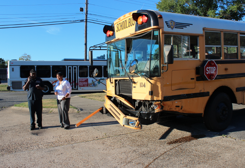 A North Little Rock School District bus is damaged Tuesday, Sept. 23, 2014, after a collision with a pickup in at Willow and Pershing in North Little Rock.