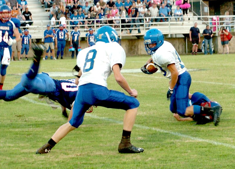 Photo by Mike Eckels A Mountainburg player grabs the heals of Decatur&#8217;s Joey Barnes (#10) attempting a tackle during the Bulldog/Dragons game at Dragon Stadium in Mountainburg on Friday. Barnes broke this tackle and three more before making a touchdown.