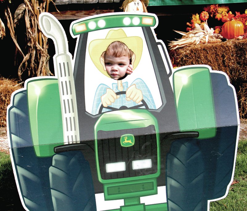 Submitted Photo Little Samuel Holloway was enjoying the fun at the Hiwasse Fall Festival last Saturday. There were activities for folks of all ages and Samuel found the sunny day was perfect for driving a big John Deere tractor and seeing all the sights.