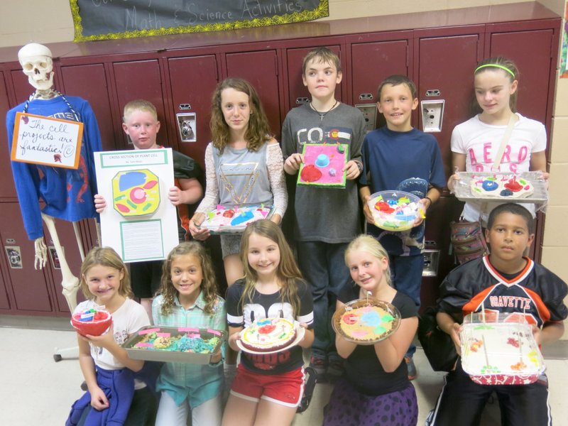 Photo by Susan Holland Students in the fifth grade at Gravette Upper Elementary School made models of plant cells after they recently completed a science unit on plants. These students displaying their projects are from Mrs. Rigg&#8217;s homeroom class but are in Dorothy Hadley&#8217;s science class. Pictured are Tanner Stearman (front, left), Kylee Krewson, Kiley Davidson, Kylee Poulter-Hendren, Bryce Waeltz, Sam Mayo (back, left), Holly Howard, Dagan Russell, Nicholas Hamilton and Holly Robinson. They are joined by &#8220;Bonzie,&#8221; who guards the door to Mrs. Hadley&#8217;s classroom.
