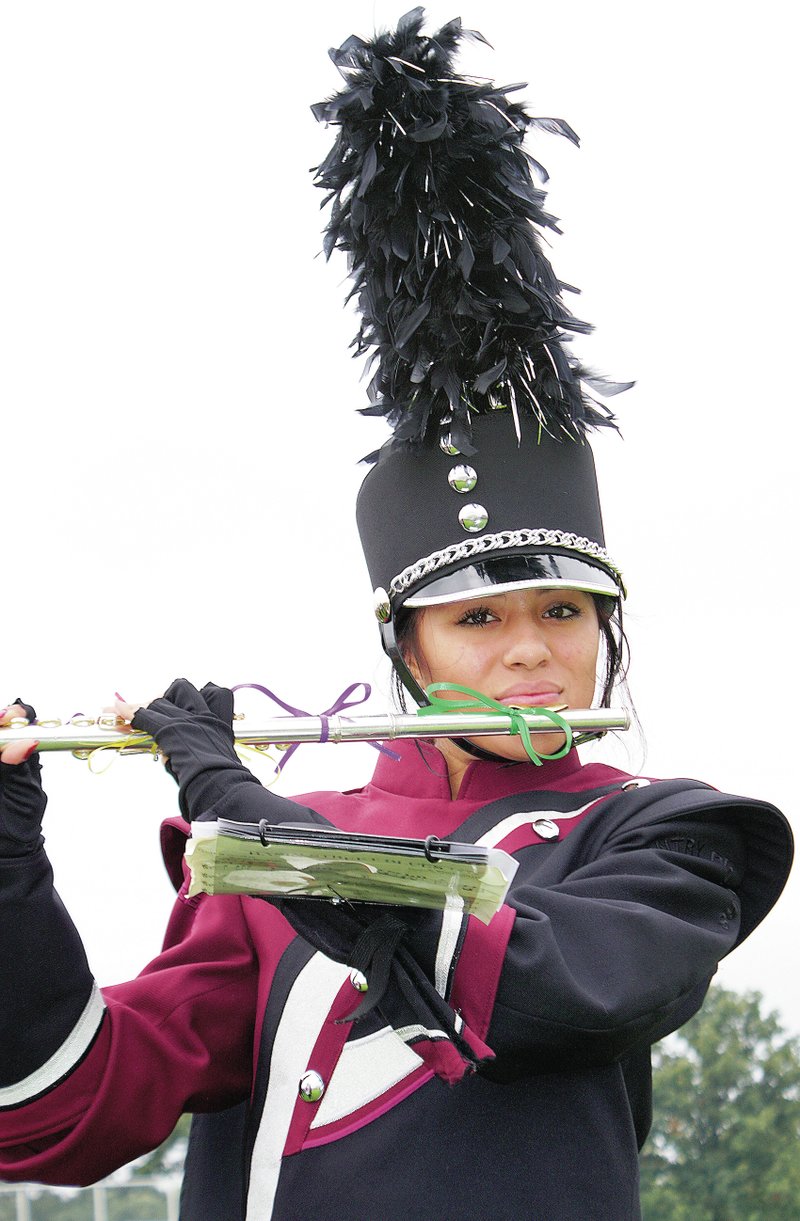 Photo by Randy Moll Jocelyn Torres plays the flute in Gentry&#8217;s marching band during homecoming ceremonies on Friday in Pioneer Stadium.