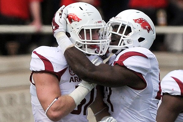 Arkansas linebackers Brooks Ellis, left, and Martrell Spaight celebrate during a game Saturday, Sept. 13, 2014 at Jones AT&T Stadium in Lubbock, Texas. 