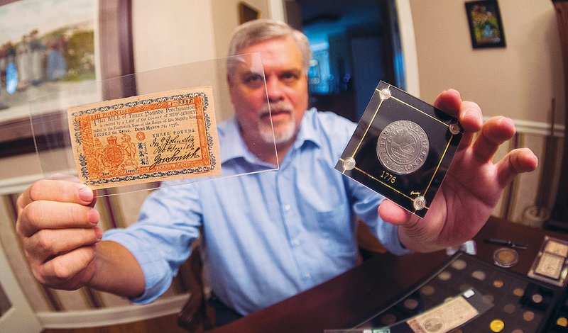 Will Nipper of Conway holds a 1776 Continental currency coin in his left hand, and in his right hand, a 1776 3-pound note from the Colony of New Jersey. The pieces are part of his personal collection. Nipper, the author of the book In Yankee Doodle’s Pocket: The Myth, Magic and Politics of Money in Early America, will be honored with an award in October from the Colonial Coin Collectors Club during its annual convention in Baltimore, Md.
