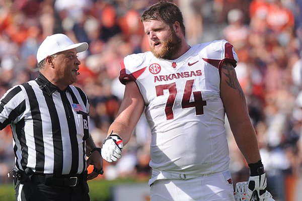 Arkansas offensive lineman Brey Cook talks with a referee during a game Saturday, Aug. 30, 2014 at Jordan-Hare Stadium in Auburn, Ala. 