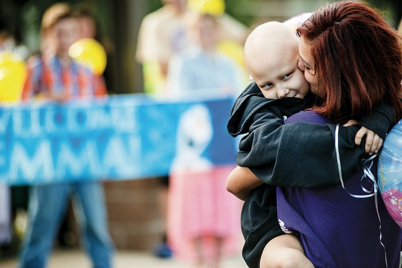 Emma Mortenson, 5, is held by her aunt Debrah Holsen after arriving to a crowd with balloons at the Quitman schools for a day in Emma’s honor. She is battling an aggressive form of bone cancer. 