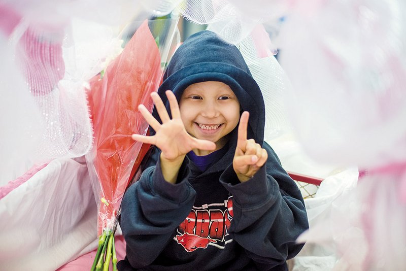 Emma Mortenson, 5, shows how old she will be on Oct. 14. Emma, who has an aggresive form of bone cancer, attended events held Friday in her honor at the Quitman schools.