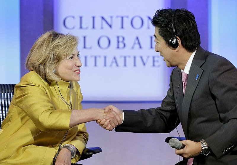 Former U.S. Secretary of State Hillary Rodham Clinton thanks Japanese Prime Minister Shinzo Abe on Wednesday for participating in a discussion on equality for women and girls at the Clinton Global Initiative in New York.