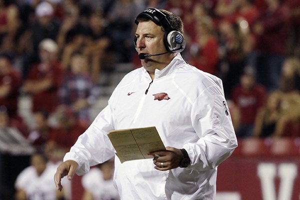 Arkansas coach Bret Bielema walks on the field during a timeout in an NCAA college football game in Fayetteville, Ark., Saturday, Sept. 20, 2014. Arkansas defeated Northern Illinois 52-14. (AP Photo/Danny Johnston)