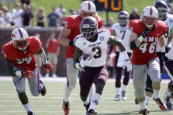 Texas A&M running back Trey Williams (3) gains yardage on a run as SMU's Derek Longoria , and linebacker John Bordano (46) give chase in the first half of an NCAA college football game, Saturday, Sept. 20, 2014, in Dallas. (AP Photo/Tony Gutierrez)