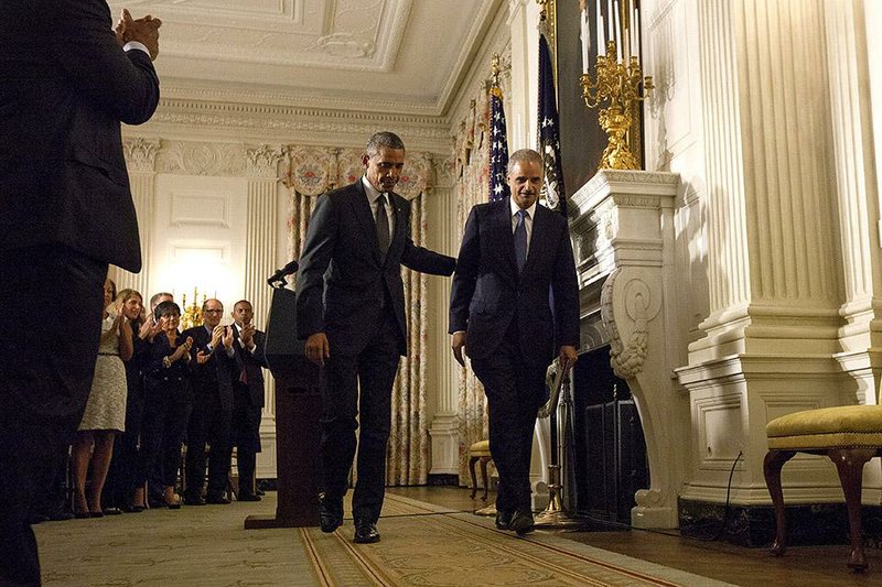 President Barack Obama, accompanied by Attorney General Eric Holder, walks off after speaking in the State Dining Room of the White House to announce Holder is resigning, on Thursday, Sept. 25, 2014, in Washington. Holder, who served as the public face of the Obama administration's legal fight against terrorism and weighed in on issues of racial fairness, is resigning after six years on the job. He is the first black U.S.  attorney general. (AP Photo/Evan Vucci)