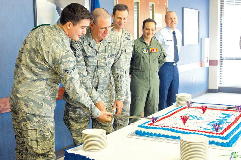 Airman 1st Class Vincenzo Galegos, left, and Senior Master Sgt. Steven Garrison cut the cake at the Little Rock Air Force Base’s birthday celebration Sept. 18.