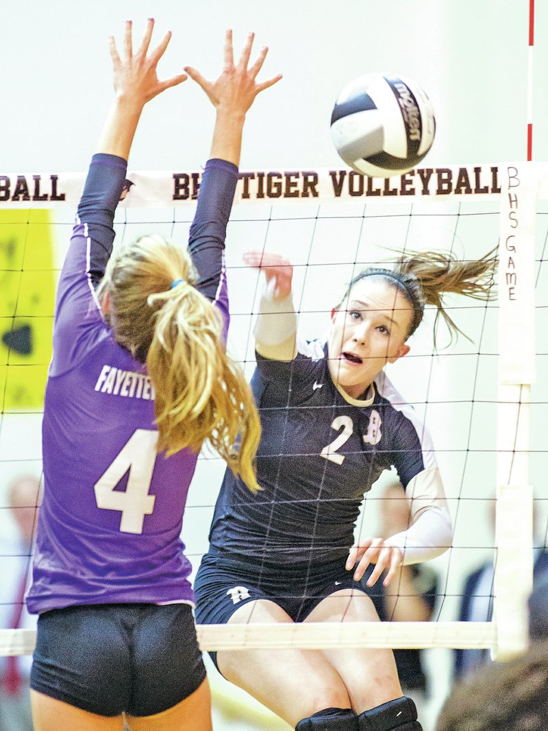 STAFF PHOTO JASON IVESTER Anna LeDuc of Bentonville sends a shot past Hadley Spresser of Fayetteville on Thursday in Bentonville.