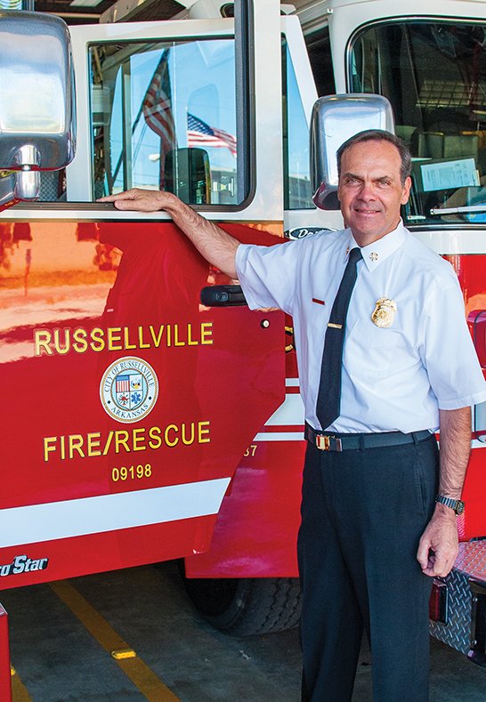 Russellville Fire Chief John Cochran stands by two firetrucks that are so close in the cramped fire station that their doors hit each other when opened at the same time. Relief will come in 18 to 24 months when a new central fire station is built in the city. Cochran said last week that he was sending out requests for proposals from architects for the project, expected to cost $6.5 million.