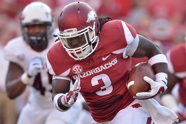 Arkansas running back Alex Collins carries the ball during the first quarter of the game against Northern Illinois in Reynolds Razorback Stadium in Fayetteville on Saturday, Sept. 20, 2014. 
