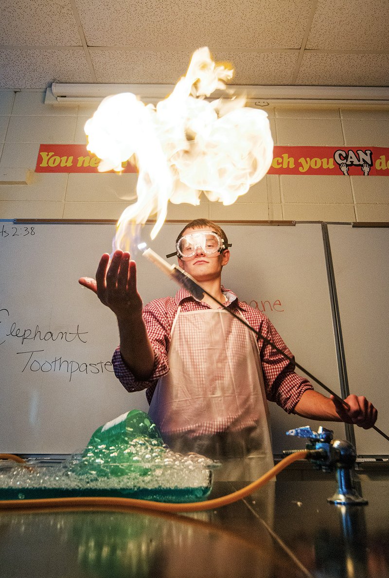 Harding Academy student Ross Eichhorn lights a bubble filled with methane.