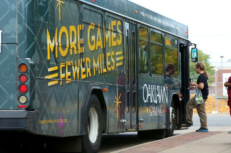 A Central Arkansas Transit Authority bus promoting Oaklawn’s casino in Hot Springs stops for passengers at the River Cities Travel Center in Little Rock earlier this month.
