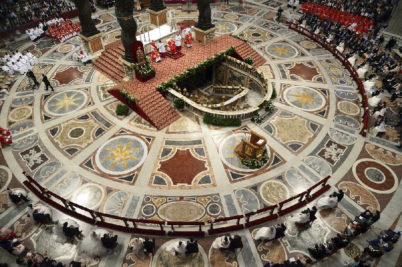 Pope Francis, top center beneath a baldachin, weds twenty couples in St. Peter's Basilica, at the Vatican, Sunday, Sept. 14, 2014. Forty "I do's", or "Si" in Italian, were pronounced in St. Peter's Basilica Sunday as Pope Francis married 20 couples, with one bride already a mother. Francis in his homily likened families to the "bricks that build society."