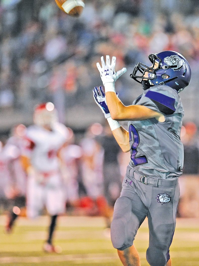  STAFF PHOTO ANDY SHUPE Bruce Armstrong of Fayetteville catches a touchdown pass behind the Fort Smith Northside defense during the first half Friday at Harmon Stadium in Fayetteville.