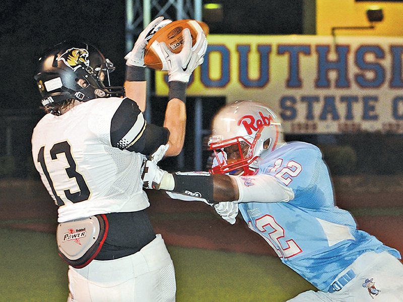  TIMES RECORD BRIAN D. SANDERFORD Jordan Racy, right, of Fort Smith Southside hits Bentonville&#8217;s Derek Hembry, knocking the ball loose in the end zone, preventing a touchdown on Friday.