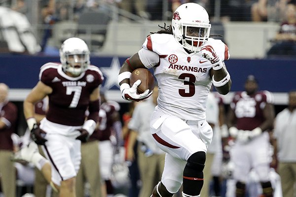 Arkansas running back Alex Collins (3) sprints past Texas A&M linebacker Jordan Mastrogiovanni (7) for a long run on his way to the end zone for a touchdown in the first half of an NCAA college football game, Saturday, Sept. 27, 2014, in Arlington, Texas. (AP Photo/Tony Gutierrez)