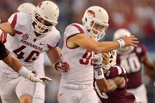 Arkansas punter Sam Irwin-Hill breaks the tackle of Texas A&M cornerback Nick Harvey on his way to running a touchdown during the second quarter of the Southwest Classic at AT&T Stadium in Arlington, Texas on Saturday, Sept. 27, 2014. 