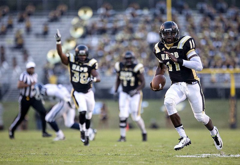 Arkansas Democrat-Gazette/MELISSA SUE GERRITS - 09/27/2014 - UAPB's Benjamin Anderson shakes Jackson State's defense and is cheered by team mates as storms to the end zone for a touchdown during their game September 27, 2014 at UAPB. 