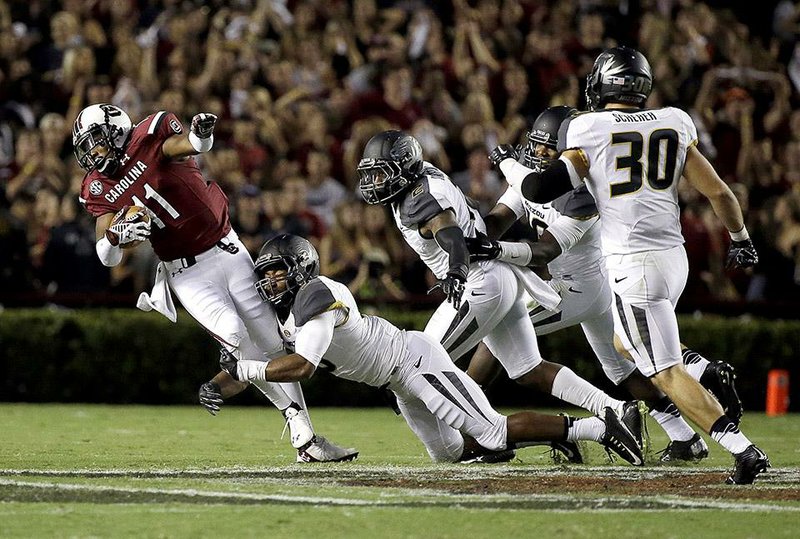 South Carolina wide receiver Pharoh Cooper (11) is tackled by Missouri safety Braylon Webb during the first half of an NCAA college football game on Saturday, Sept. 27, 2014, in Columbia, S.C. (AP Photo/Stephen B. Morton)