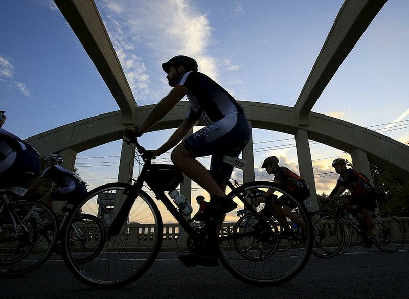 Cyclists ride Saturday along LaHarpe Boulevard near Cross Street in Little Rock during the Big Dam Bridge 100. Riders had the option of routes in lengths of 13, 20, 50, 68 and 100 miles.