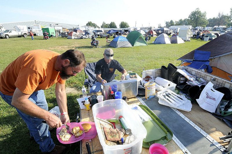 Jim Bober (left) and Jim Dooley, both of Wichita Falls, Texas, eat breakfast Saturday at the Washington County Fairgrounds in Fayetteville. The fairgrounds are open for camping, vendors and live music during the annual Bikes, Blues and BBQ rally.