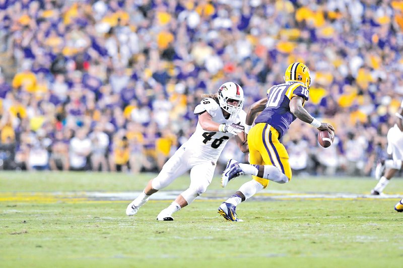 COURTESY PHOTO ULM SPORTS INFORMATION DEPT. Hunter Kissinger, Louisiana-Monroe linebacker, applies pressure to LSU quarterback Anthony Jenkins. Kissinger had nine tackles in the game and is the third-leading tackler for ULM on the season.