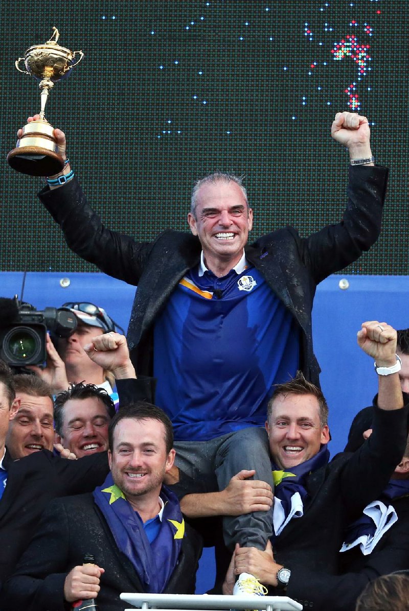 Europe players lift their  captain Paul McGinley as he holds the trophy after winning  the 2014 Ryder Cup golf tournament, at Gleneagles, Scotland, Sunday, Sept. 28, 2014. (AP Photo/Scott Heppell)